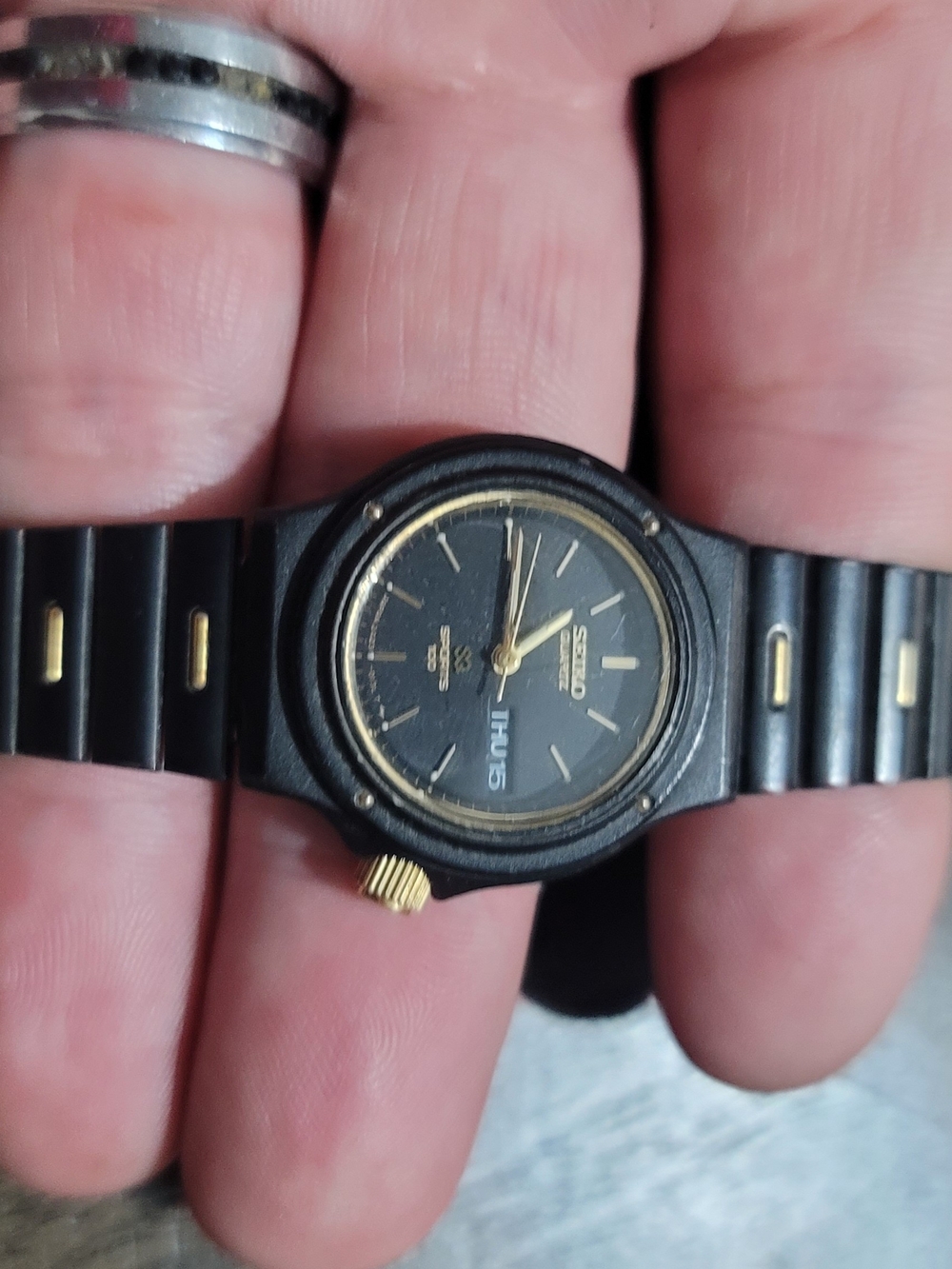 Seiko Black and Gold Analog Watch with Day Display